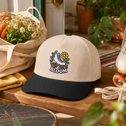 Bloom Roller Skate embroidered hat in Black / Natural on a retro plant entry bench