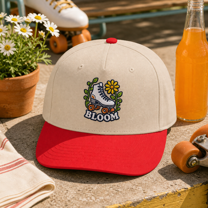 Bloom Roller Skate embroidered hat in Red / Natural on a retro skate patio table