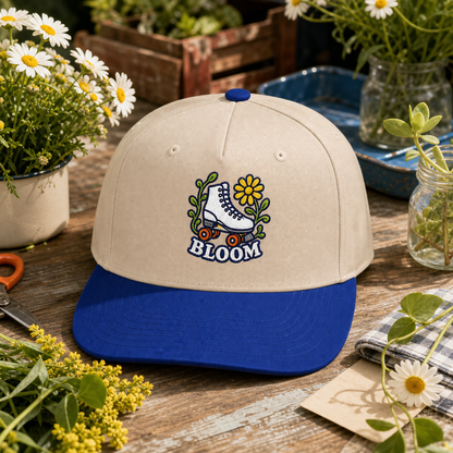 Bloom Roller Skate embroidered hat in Royal / Natural on a flower market table