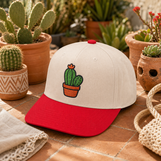 Cactus Bloom embroidered hat in Red / Natural on a terracotta tile garden table