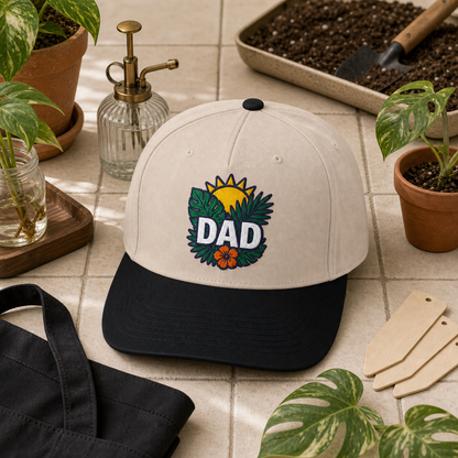 Dad Tropical Leaves embroidered hat in Black / Natural on a plant care tile counter