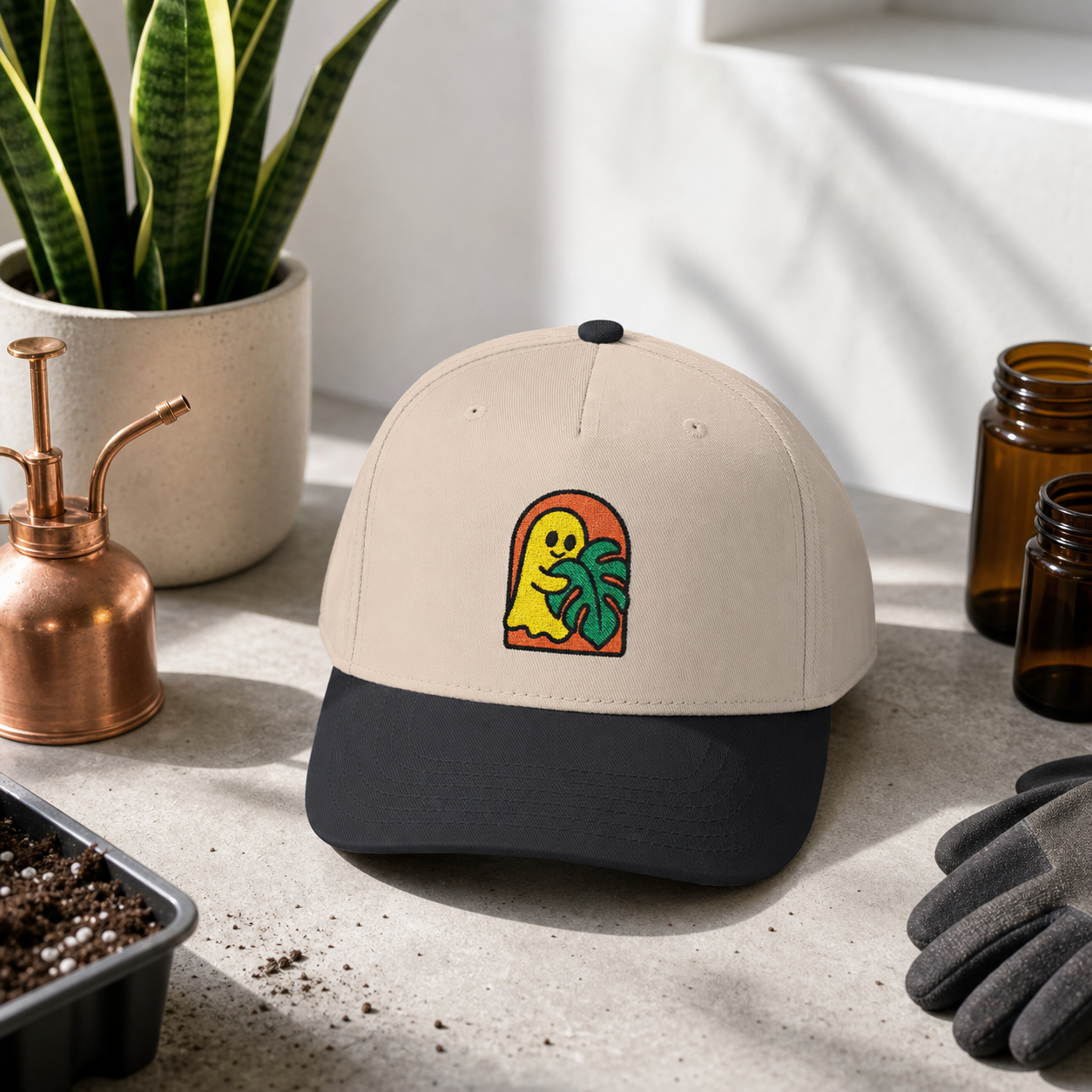 Ghost Monstera embroidered hat, Black and Natural, in a propagation studio