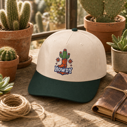 Howdy Cactus embroidered hat in green and natural on a desert greenhouse potting bench