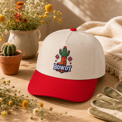 Howdy Cactus embroidered hat in red and natural on a desert flower tabletop