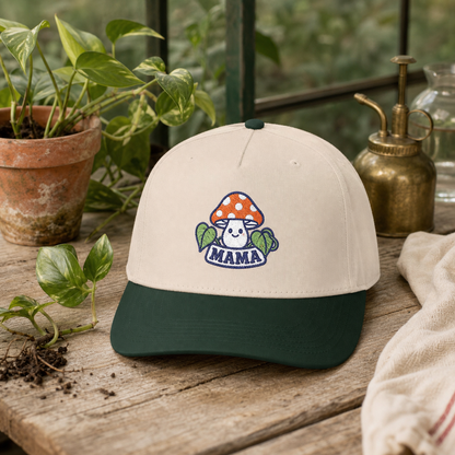 Mama Mushroom embroidered hat in dark green and natural on a greenhouse potting bench