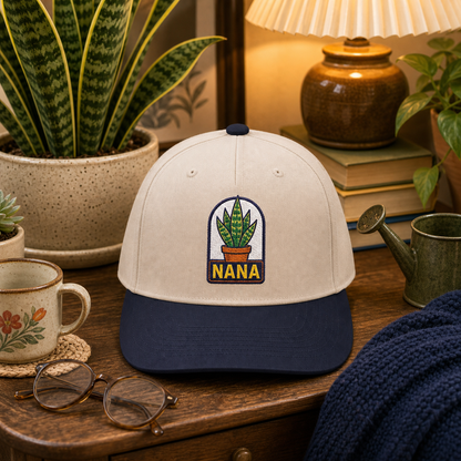 Nana Snake Plant embroidered hat in Navy / Natural in a cozy reading nook