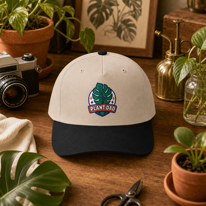 Plant Dad Hat in natural and black styled on an old-school plant collector desk